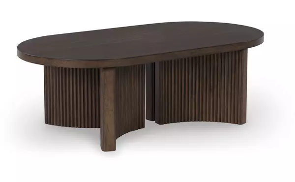 korestone dark brown oval cocktail table by ashley